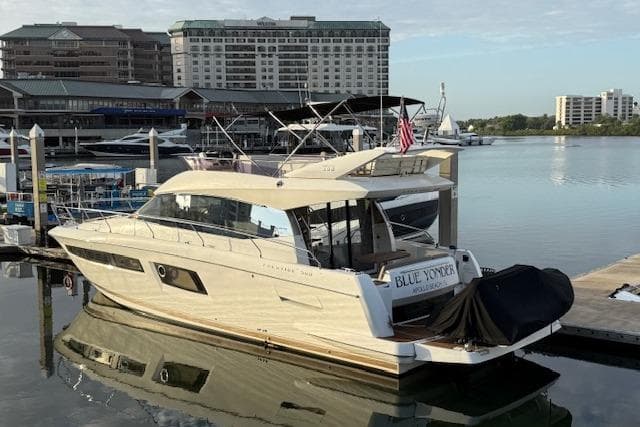 2015 Prestige 500 yacht docked at marina, with cityscape background.