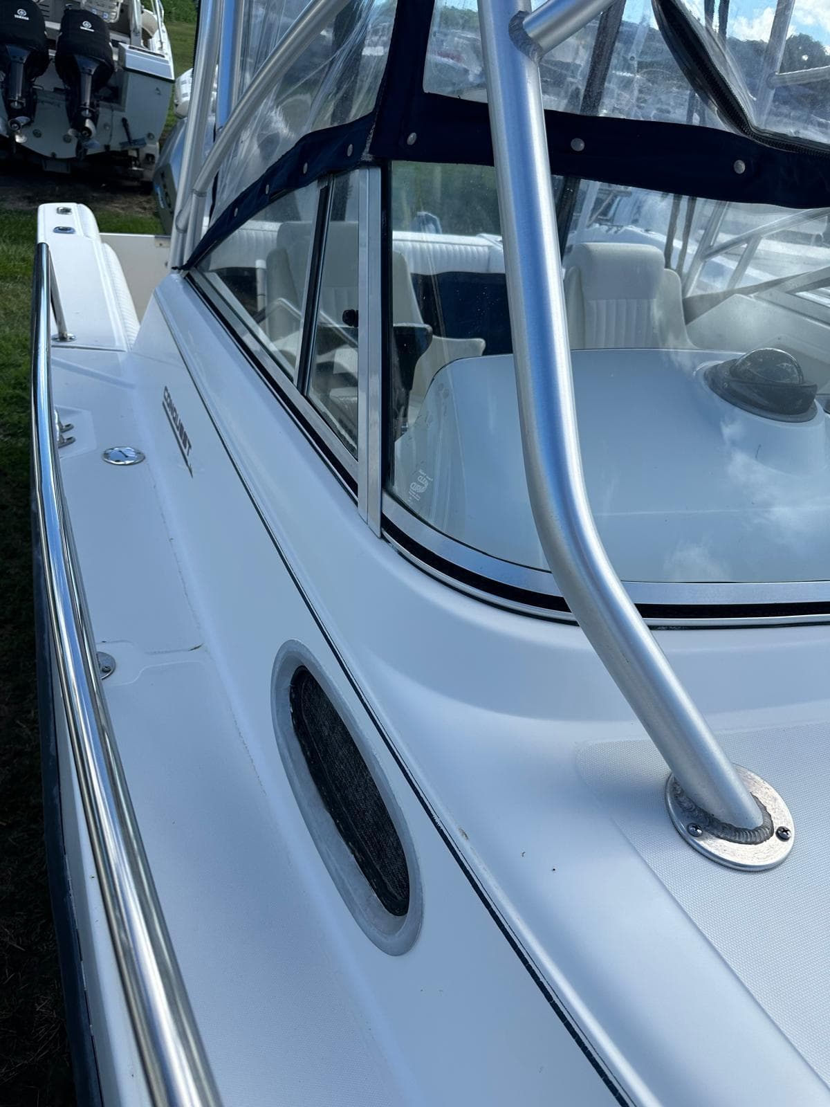 1998 Boston Whaler 23 Conquest boat, close-up of side and cockpit area.