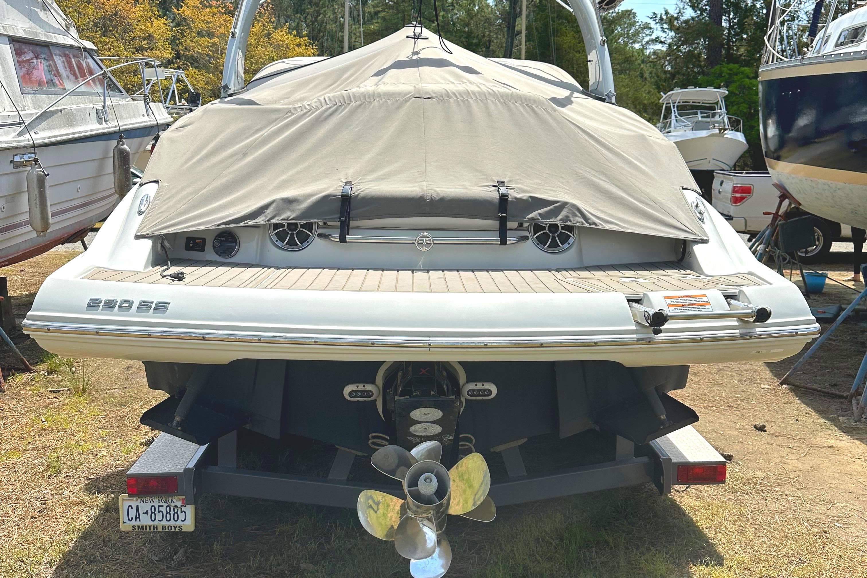2020 Crownline 290 SS boat, rear view with cover, parked on trailer.