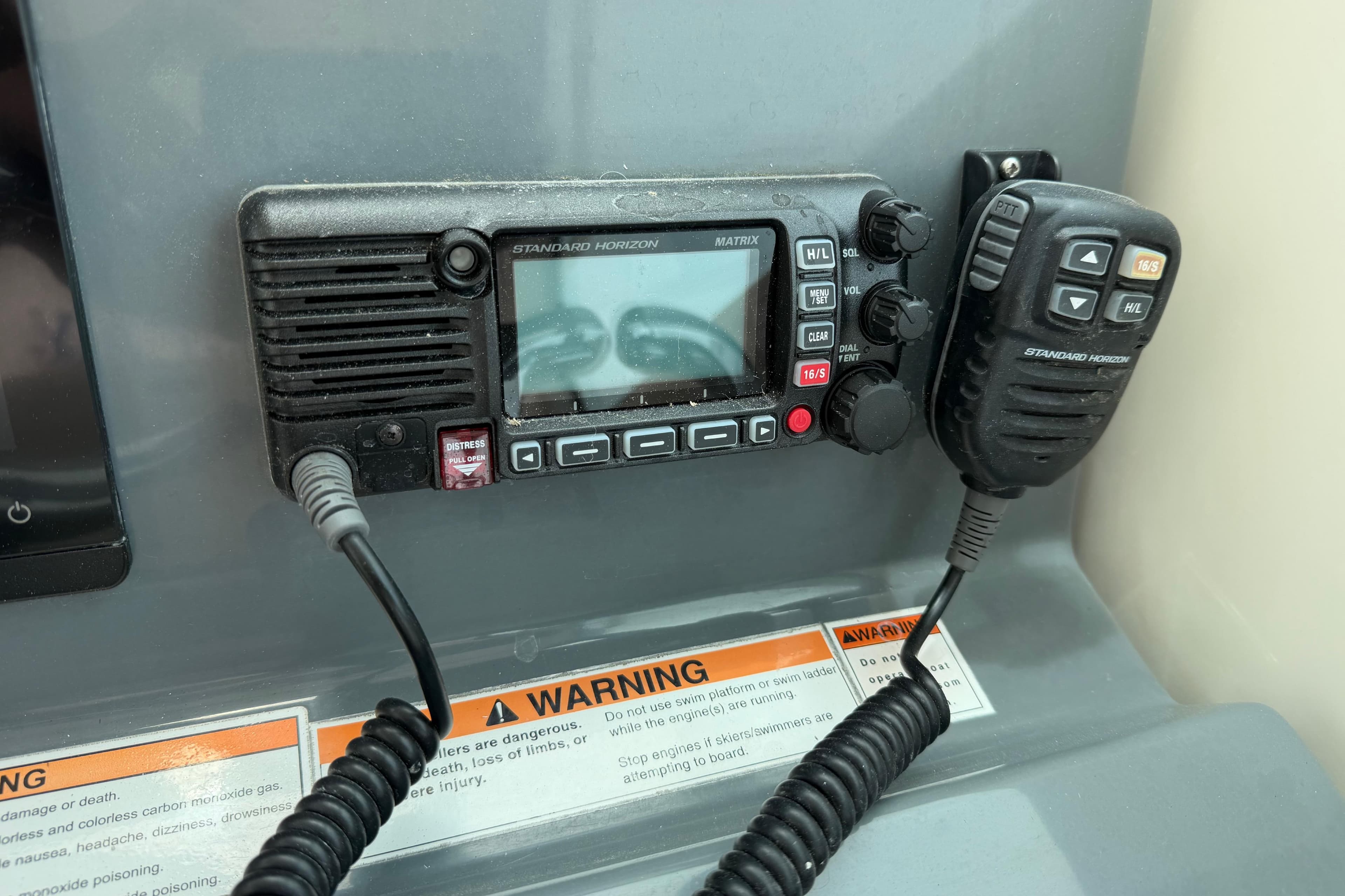 Standard Horizon marine radio on 2008 Pursuit OS 335 Offshore boat dashboard.