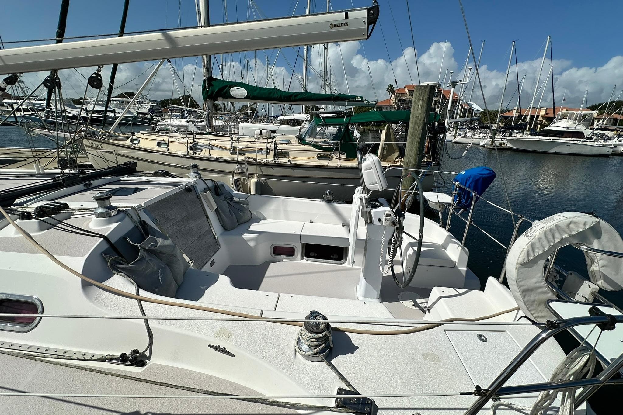 2008 Catalina 320 sailboat docked in a marina, surrounded by other boats.