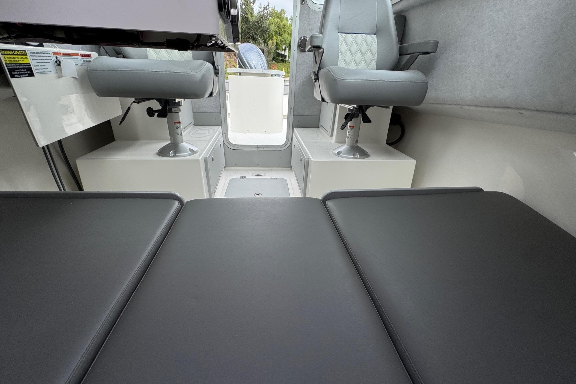 2026 Defiance Admiral 220 EX interior with cushioned seating and swivel chairs.