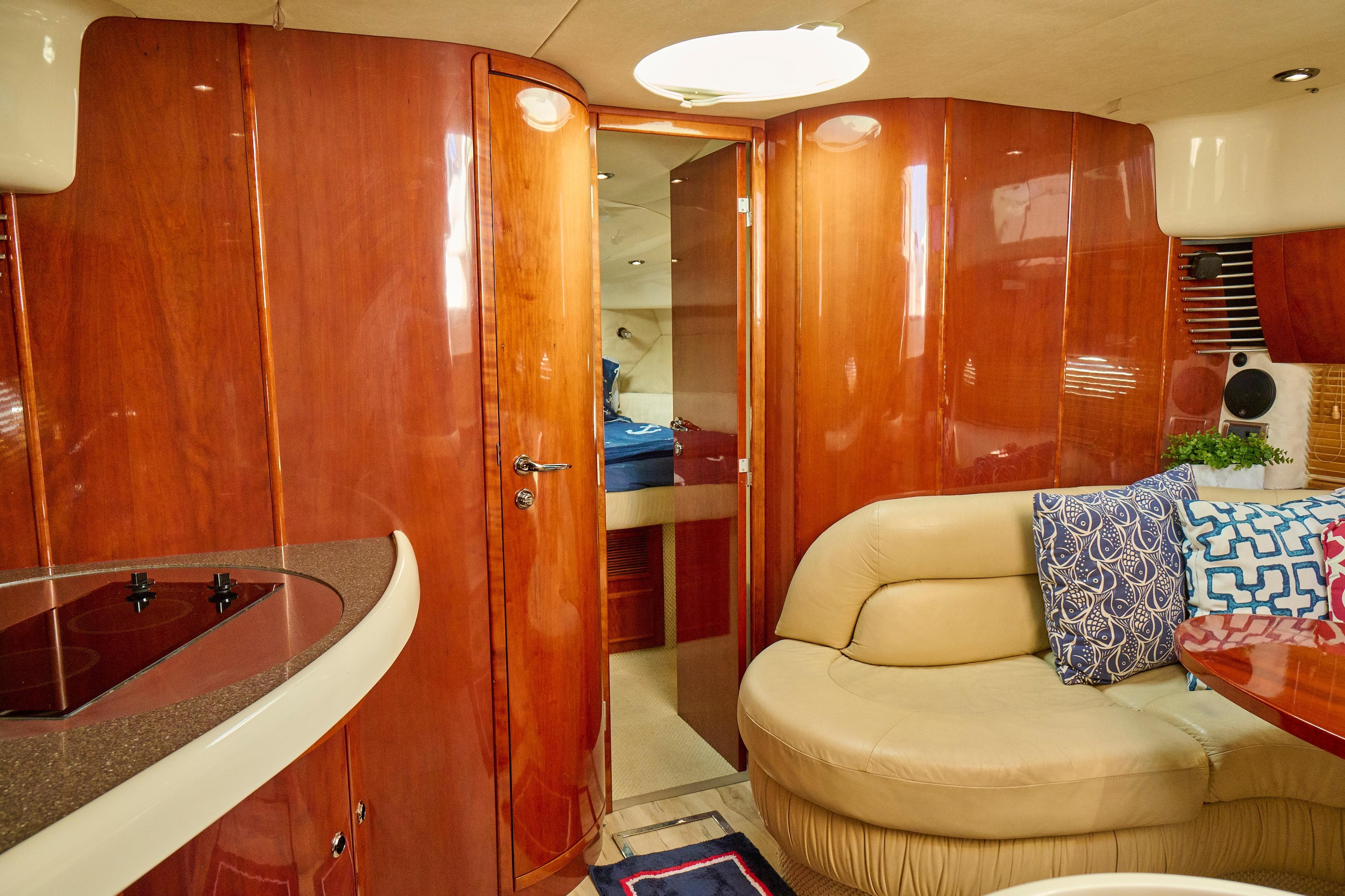 Luxurious interior of a 2001 Fairline 43 yacht with wood paneling and plush seating.