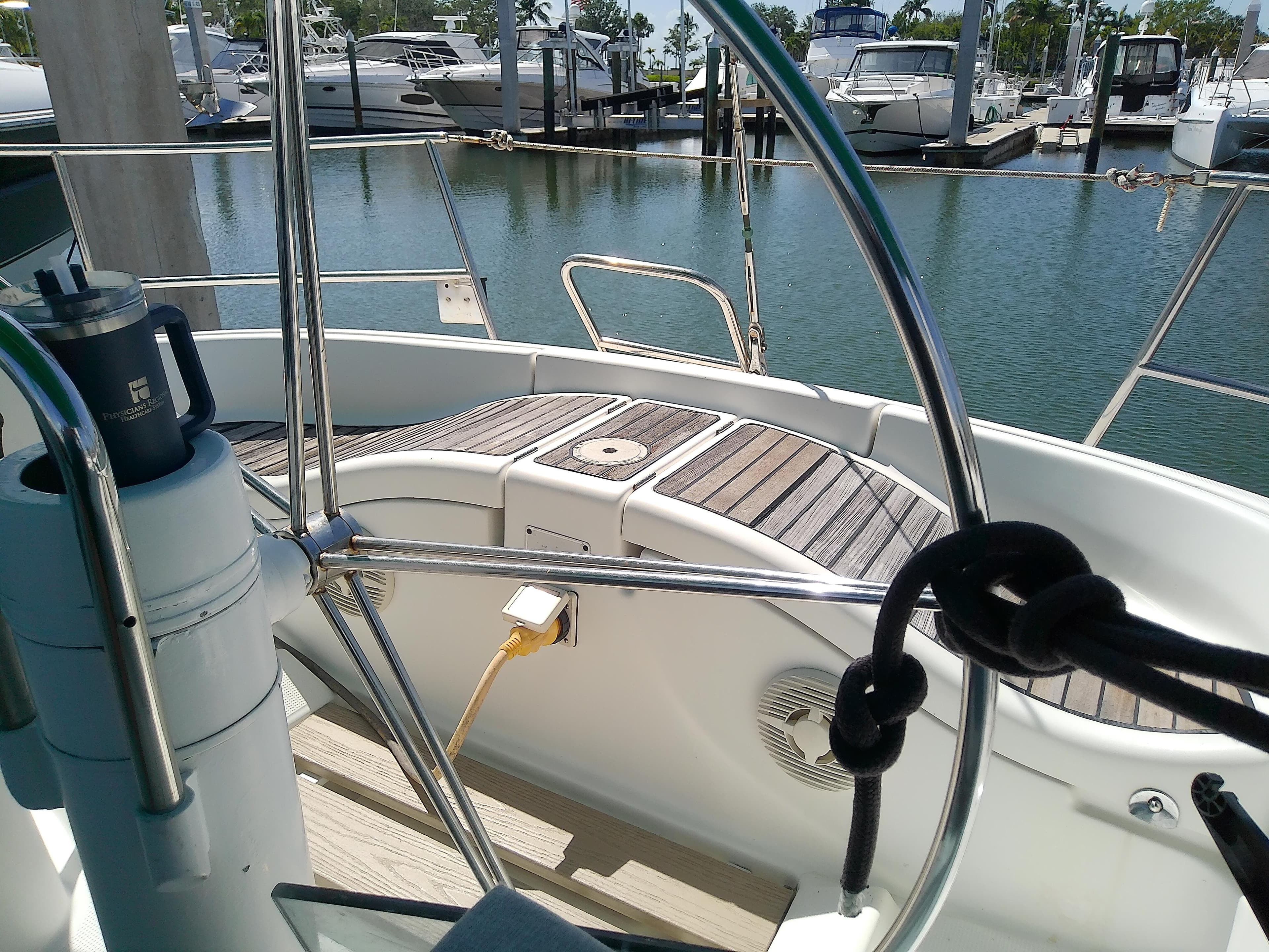 Cockpit view of a 1995 Beneteau First 42s7 sailboat docked at a marina.