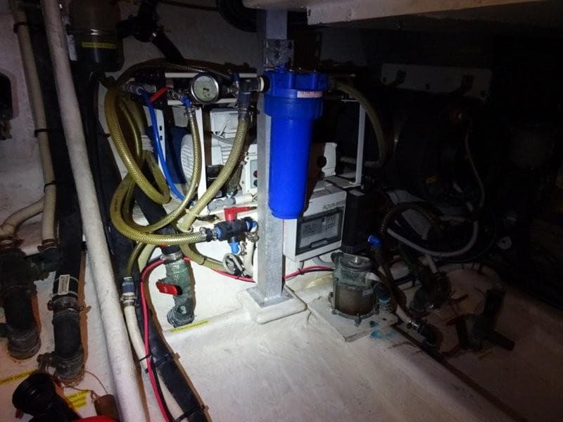 Engine room of 2000 Wauquiez 43 Pilot Saloon with hoses and filtration system.