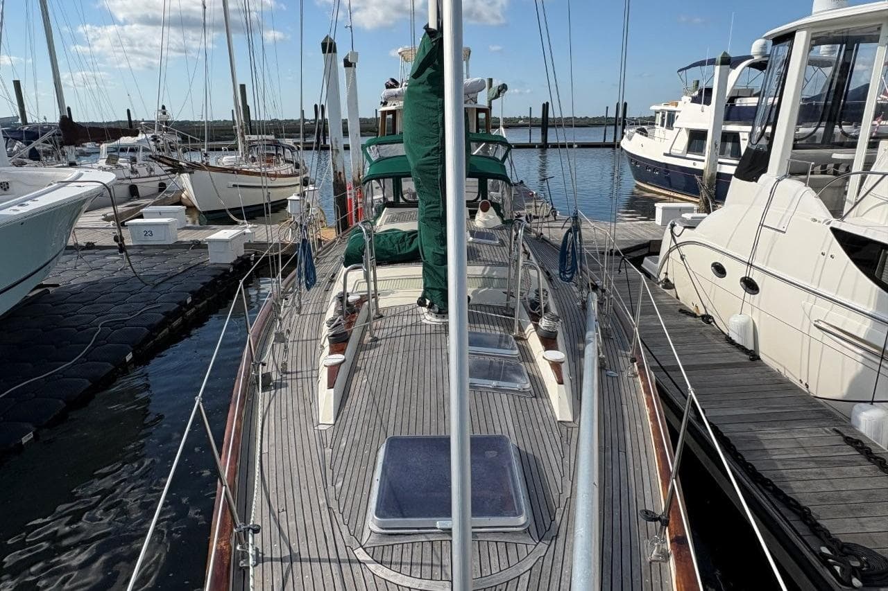 Sailboat docked at marina, Norseman 447, 1981 model, surrounded by other boats.