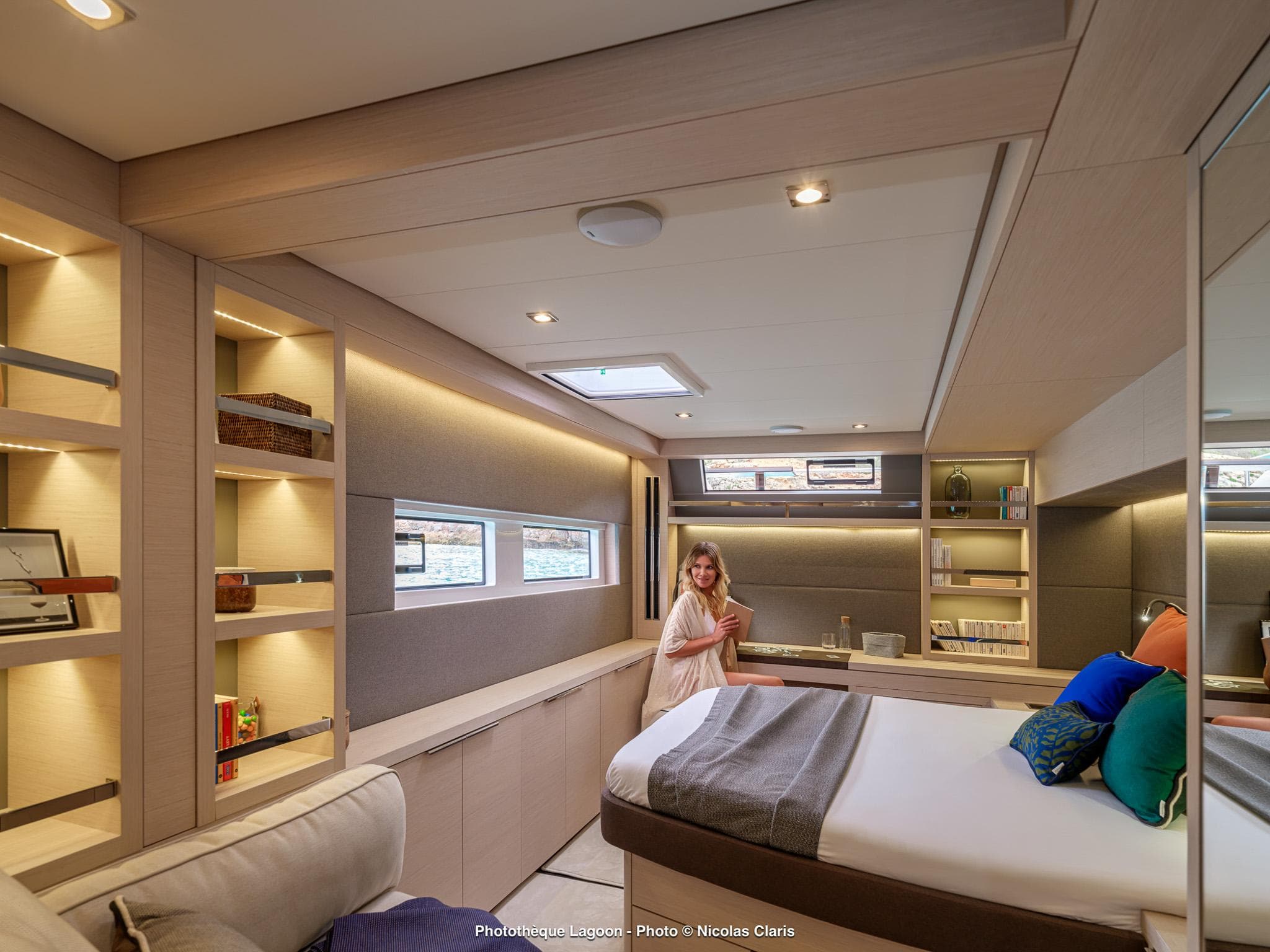 Luxurious interior of 2025 Lagoon 55 yacht with modern design and cozy bedroom.
