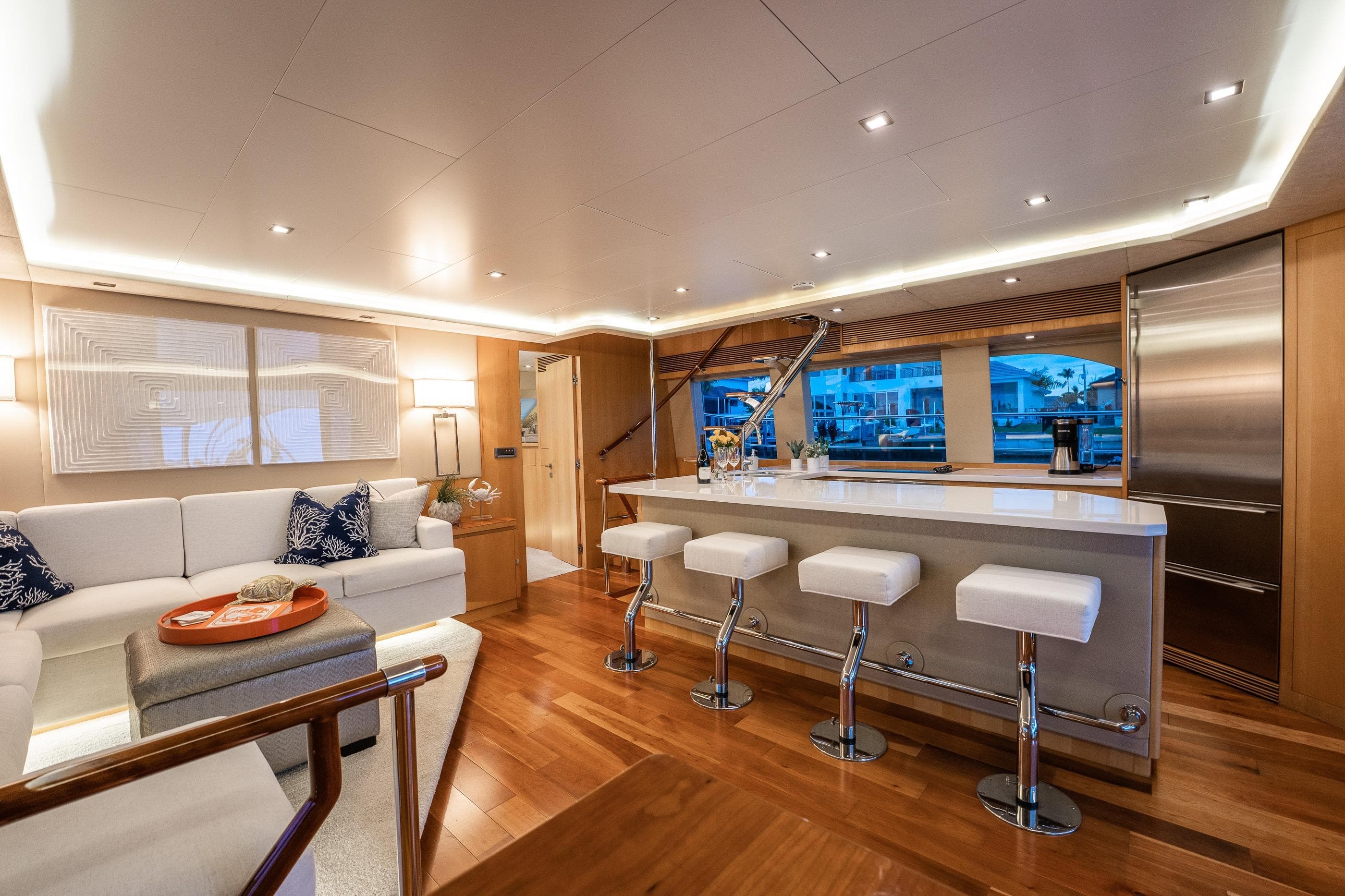 Luxurious interior of 2013 Horizon PC60 yacht with modern bar and seating area.