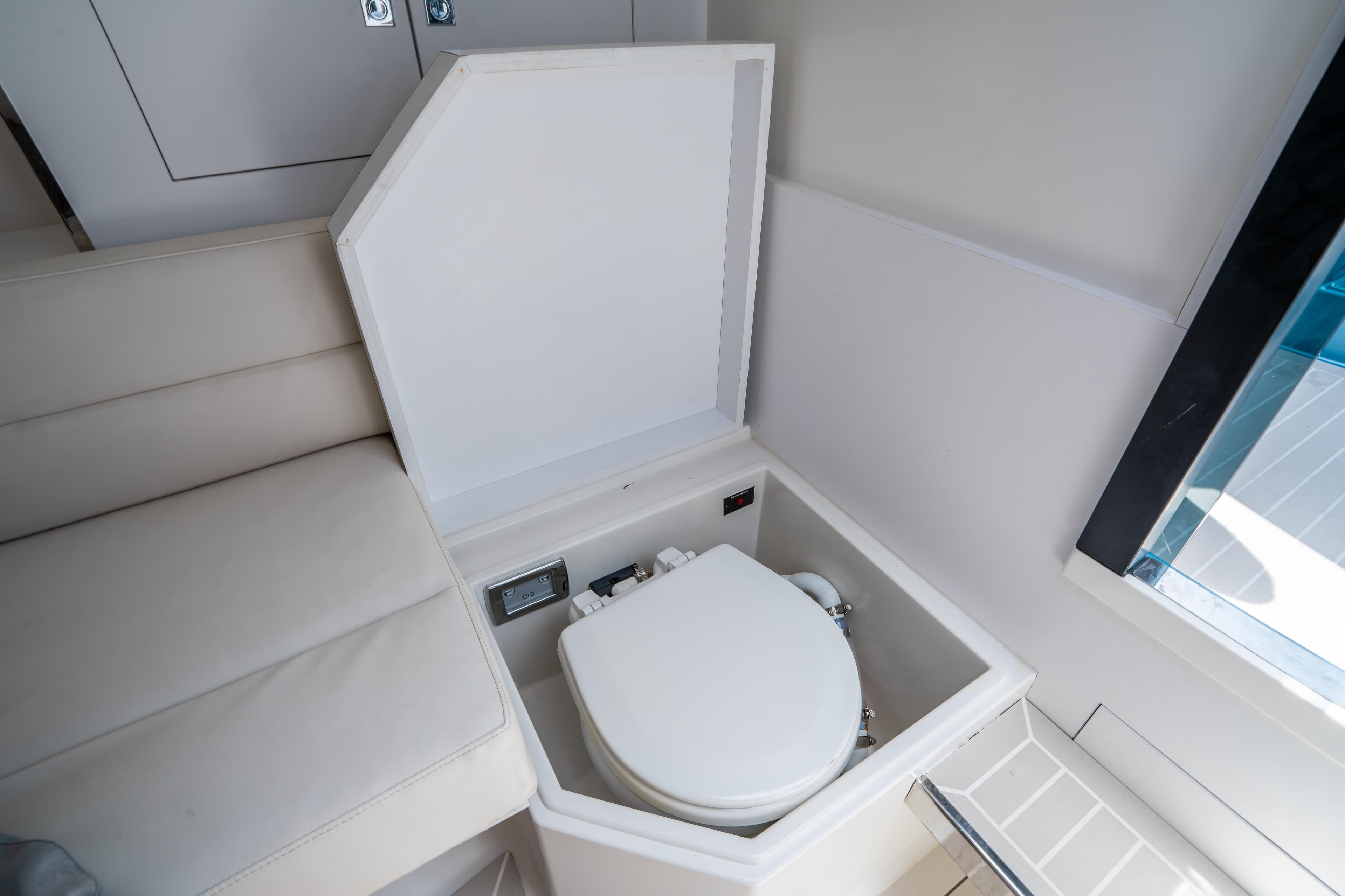 Interior of 2018 VanDutch 30 yacht featuring a compact, built-in toilet.