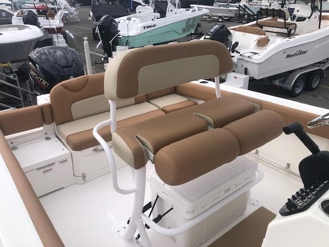2023 NauticStar 242L Offshore boat interior with tan seating and helm station.