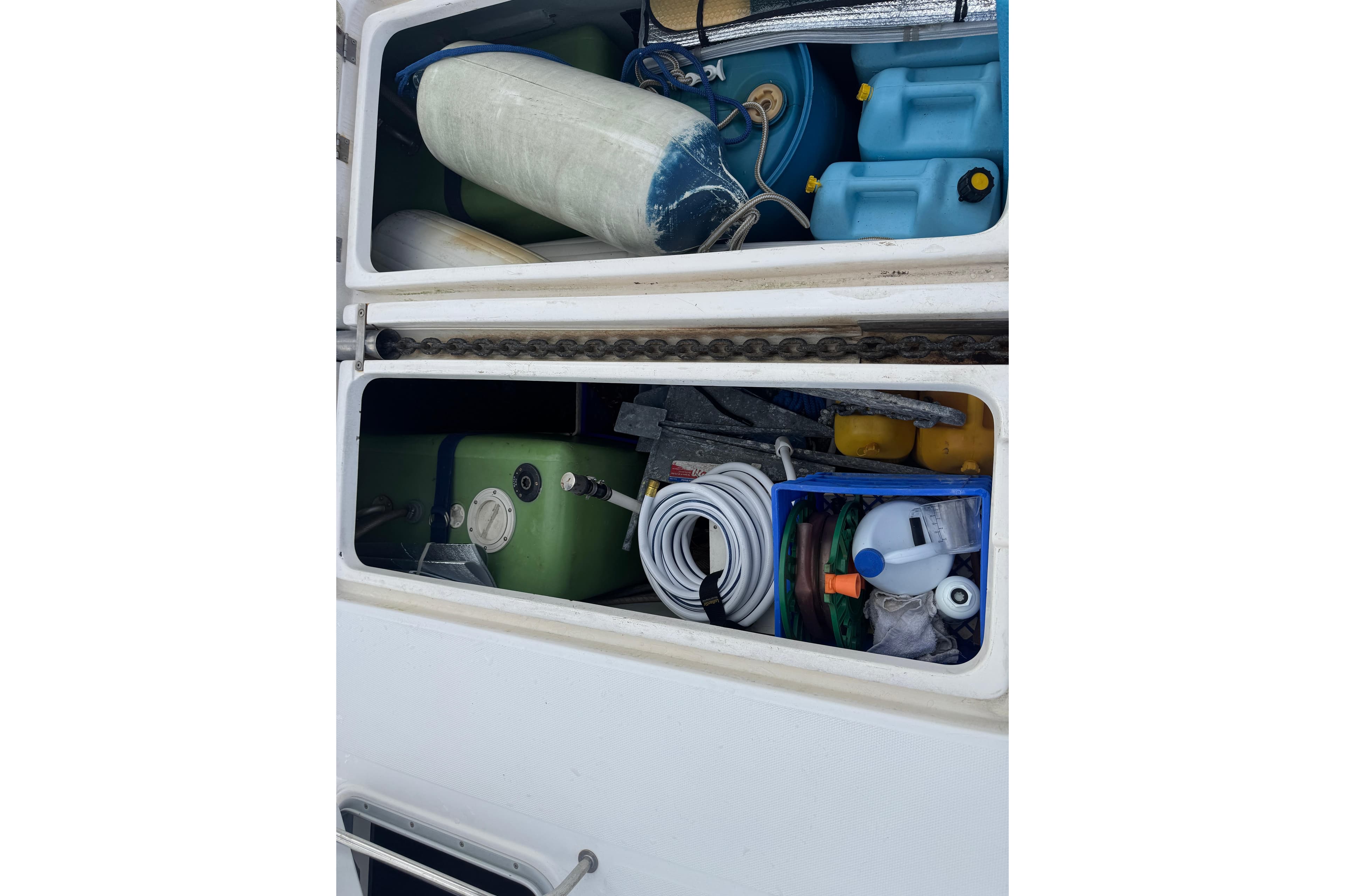 Storage compartments on a 2002 Leopard 42 boat, filled with various equipment and supplies.
