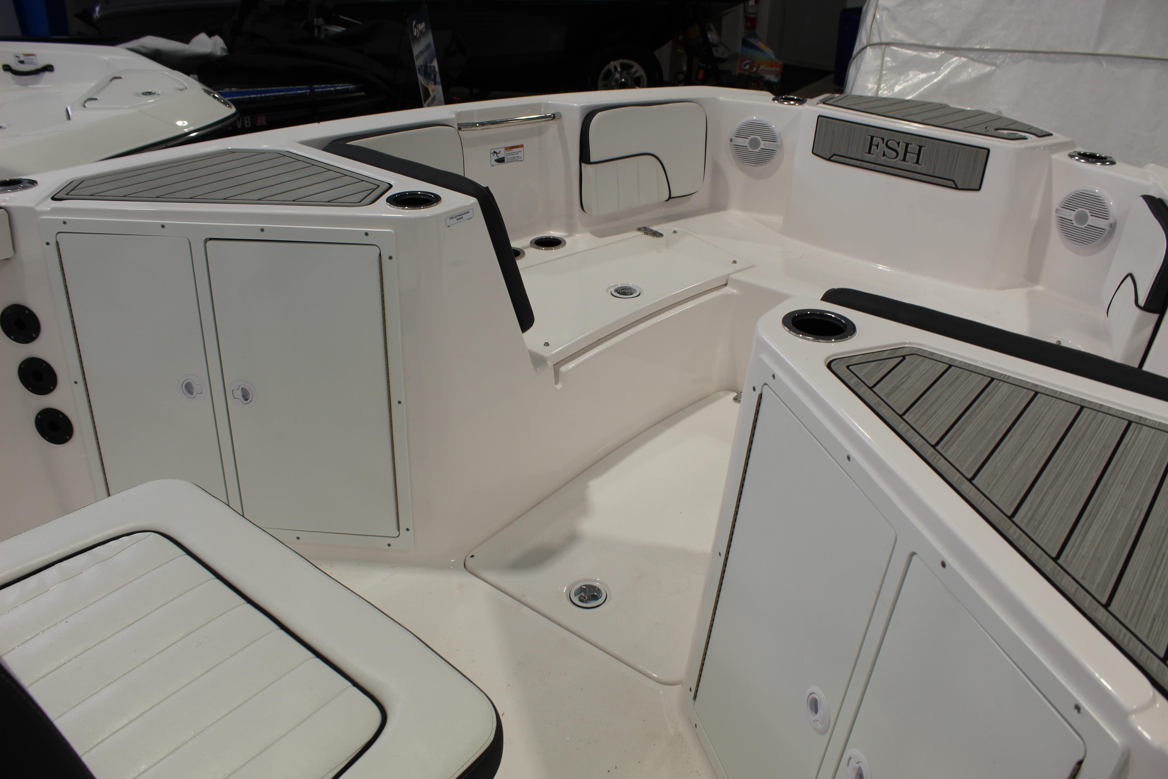 2025 Yamaha Boats 222 FSH Sport interior with seating and storage compartments.