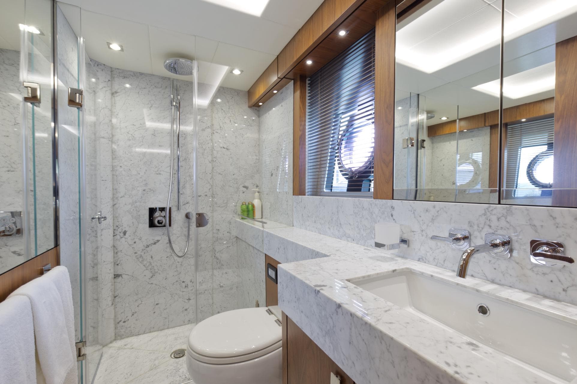 Luxurious bathroom on a 2018 Sunseeker 86 Yacht with marble finishes and modern fixtures.