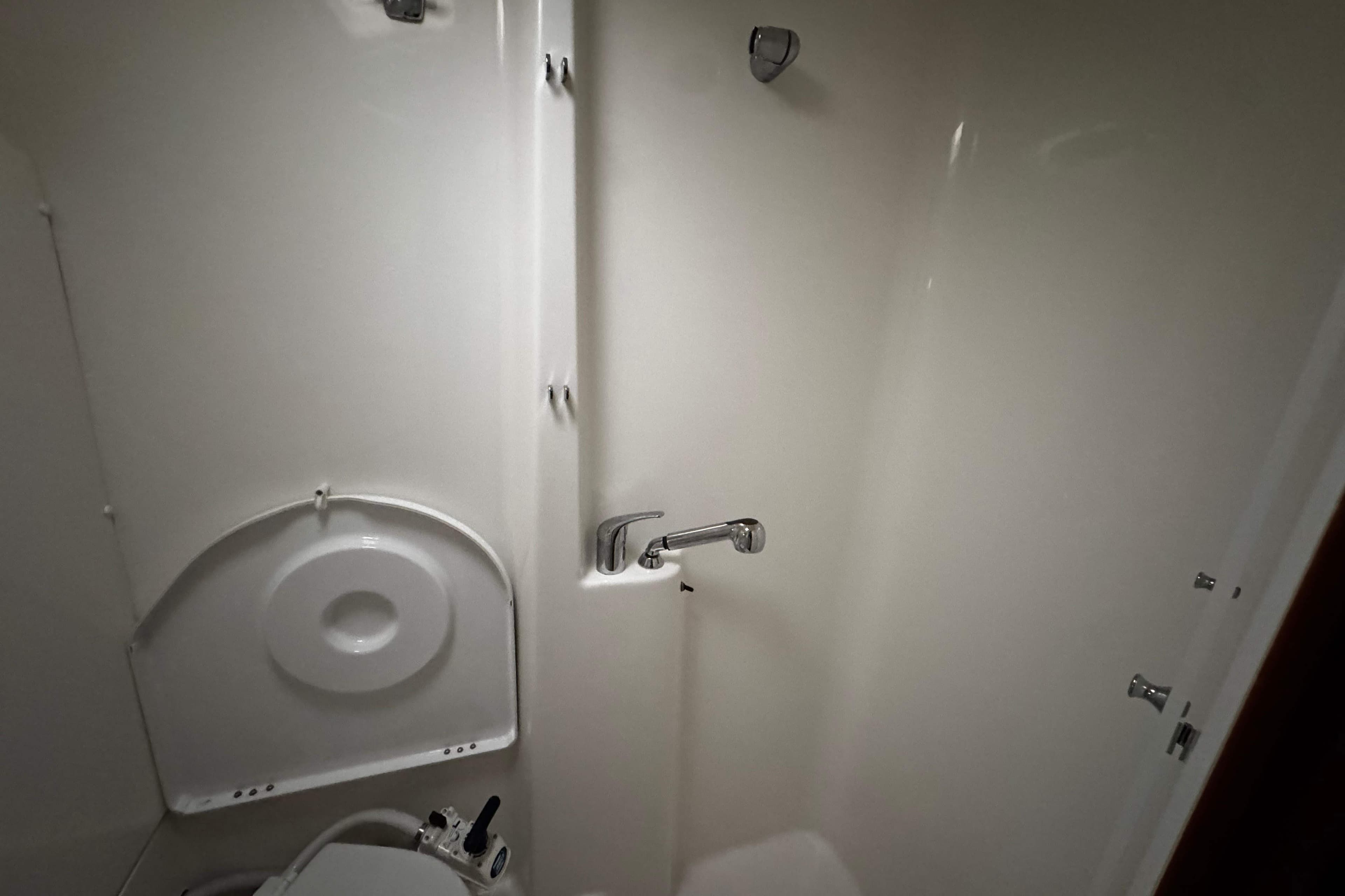 Bathroom interior of 2007 Beneteau 423 yacht, featuring shower and toilet.