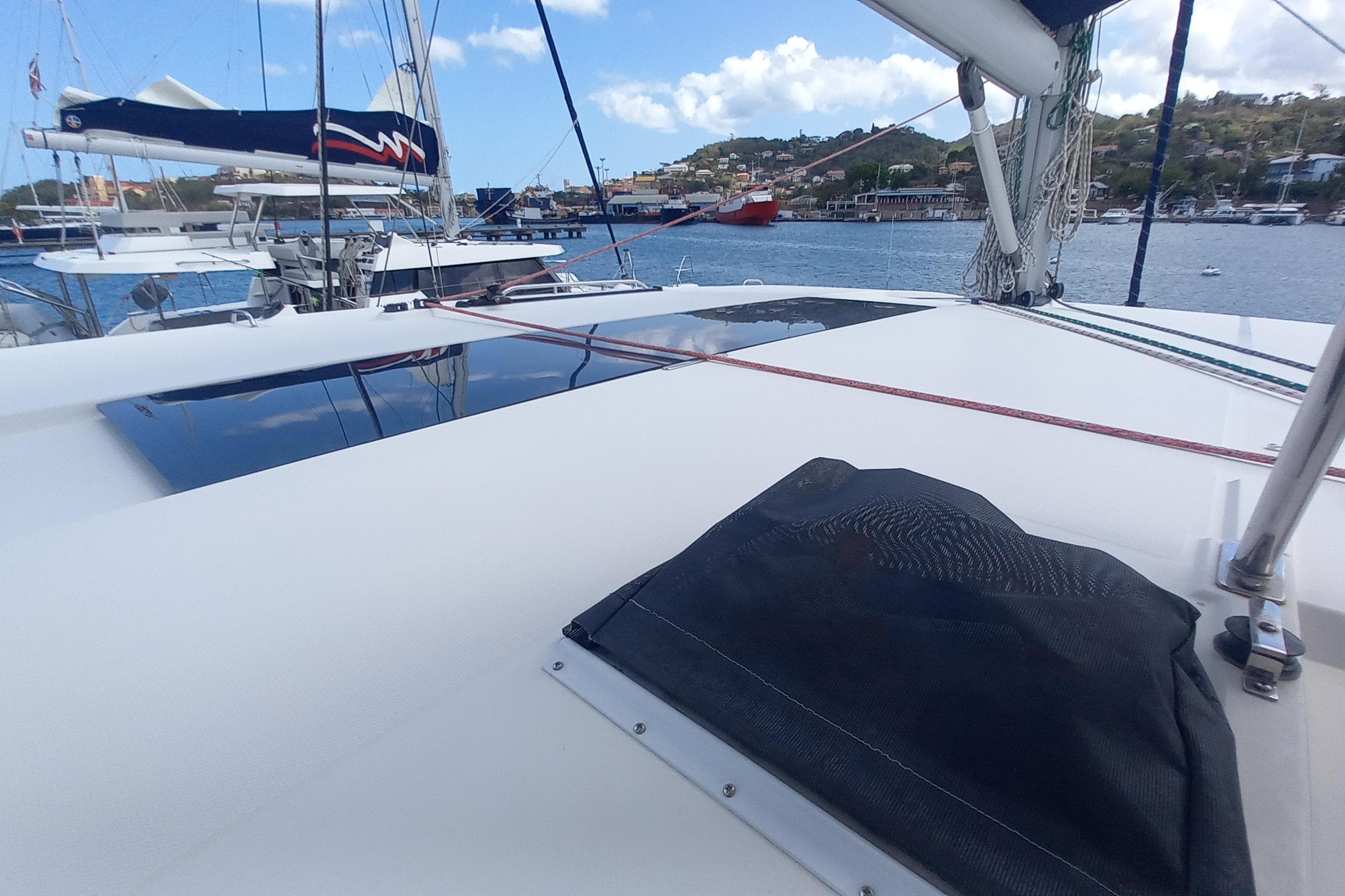 2019 Leopard 45 catamaran docked in a scenic marina with clear skies.