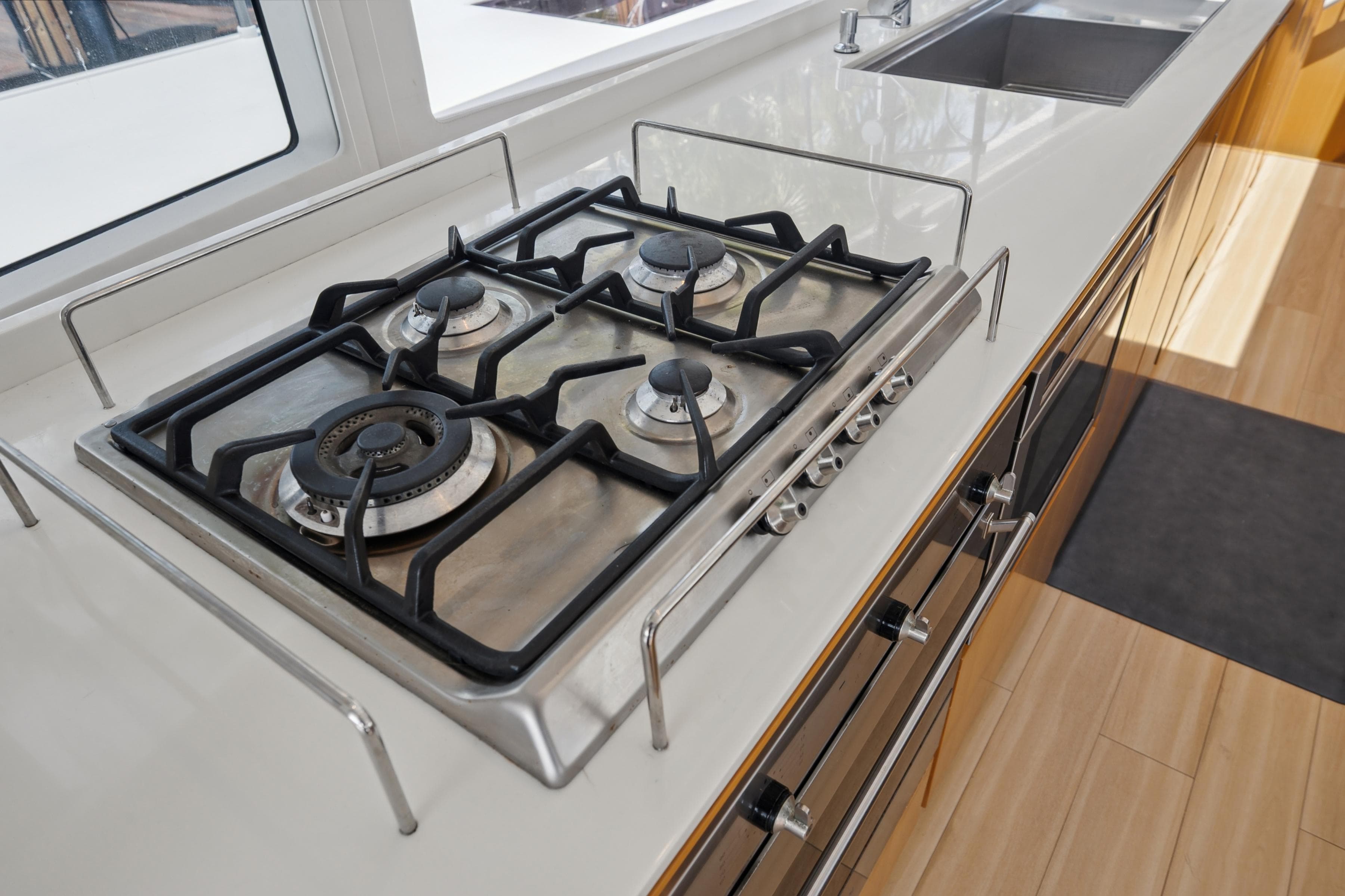 Modern kitchen with a four-burner gas stove on a McConaghy MC60 yacht, 2019 model.