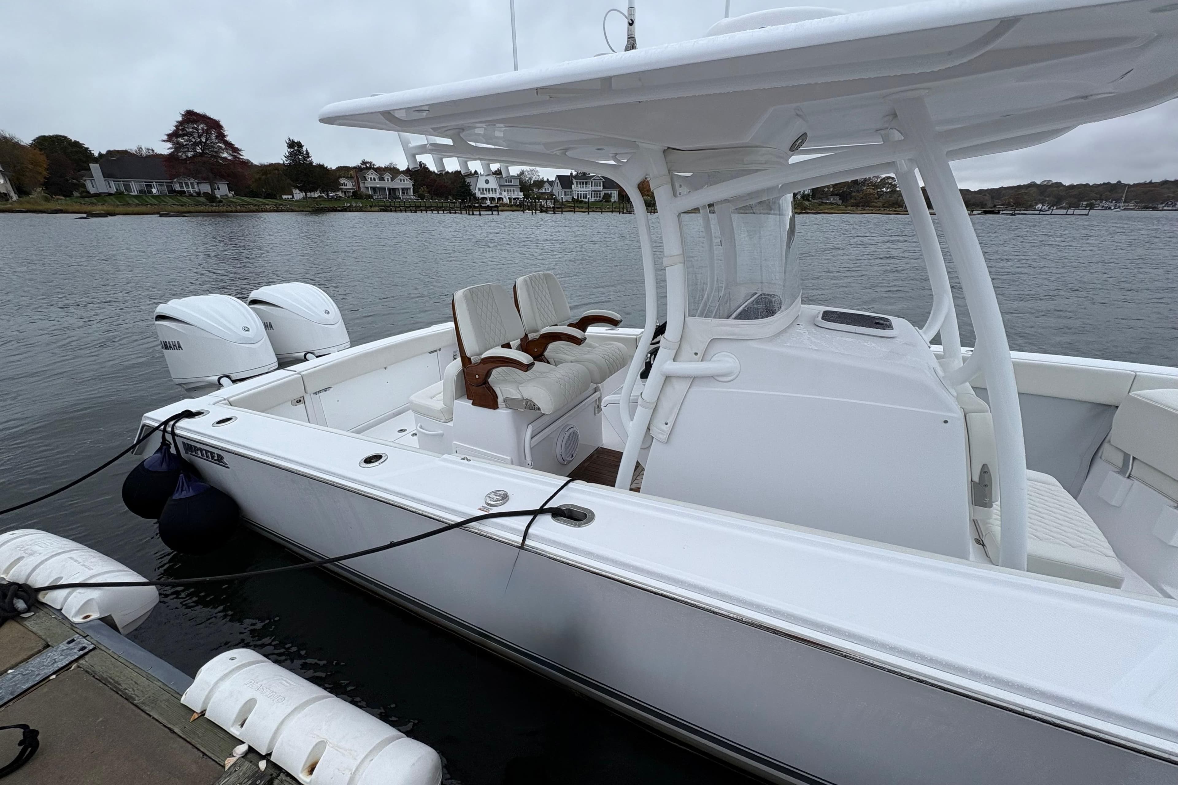 2023 Jupiter 30 boat docked, featuring dual Yamaha engines and sleek white design.