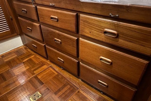 Wooden drawers and parquet flooring inside a 1986 Kadey-Krogen 42 yacht.