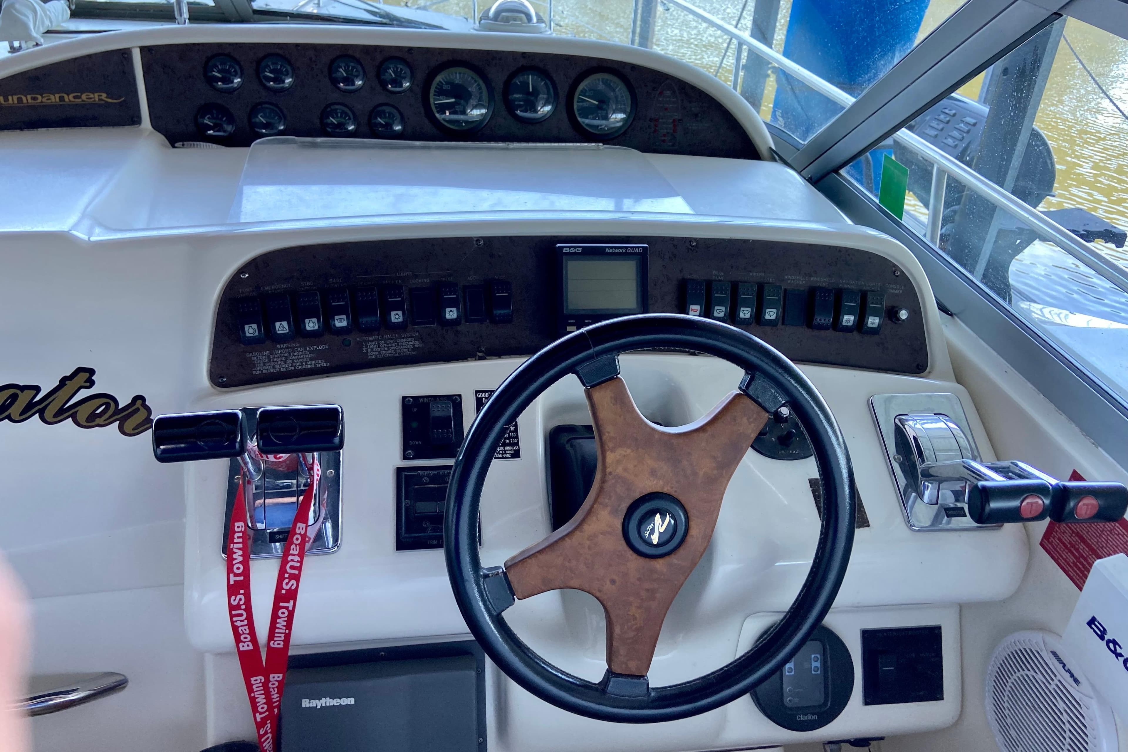 1995 Sea Ray Sundancer 370 helm with steering wheel, controls, and instrument panel.