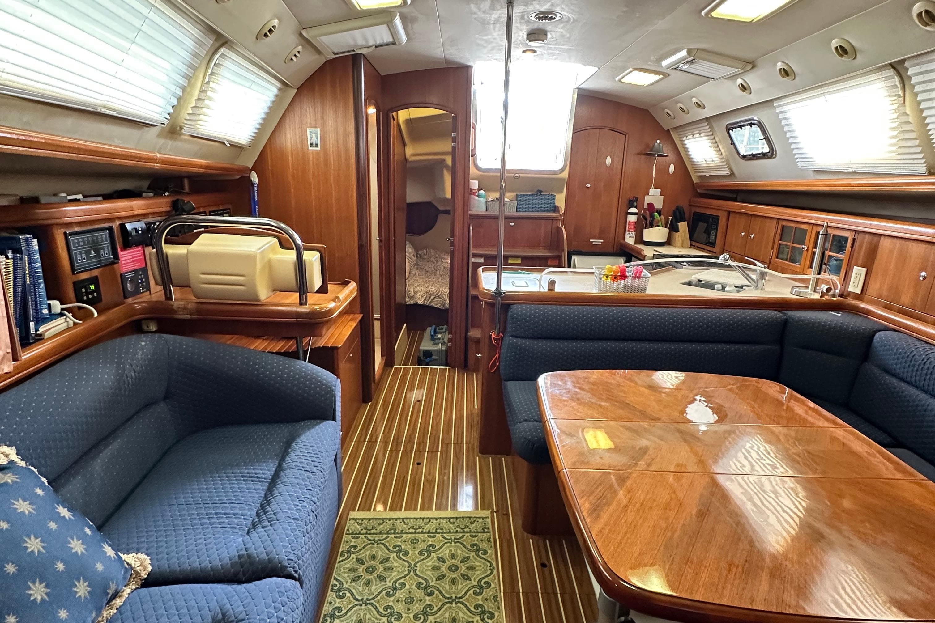 Interior of 2006 Hunter 41 Deck Salon yacht with cozy seating and wooden finishes.